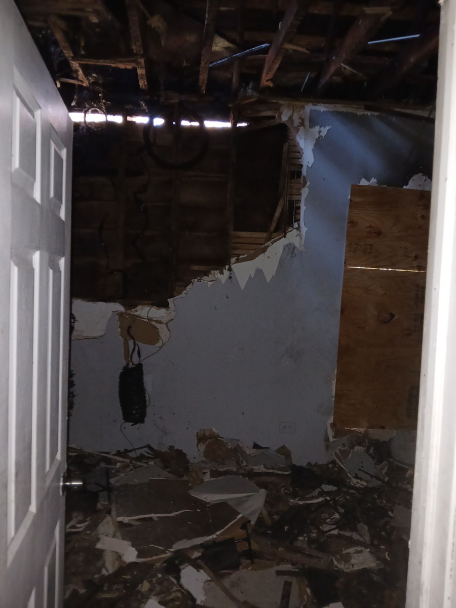 Interior room showing exposed framing and missing ceiling and wall finishes