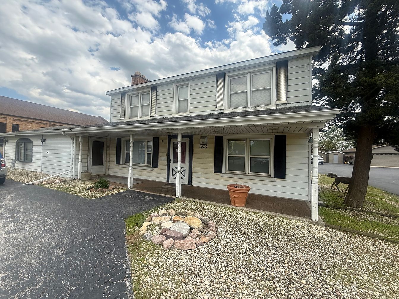 Front exterior of 2869 Glenwood Lansing Road before rehab