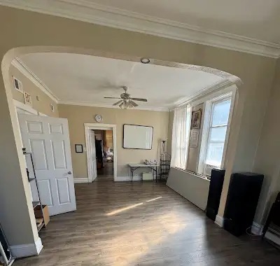 5025 South Ashland Avenue — Open interior room with archway and ceiling fans